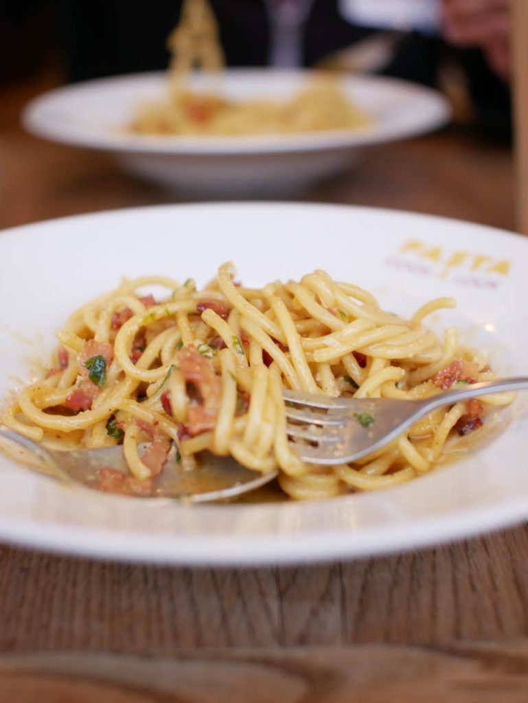 a close up shot of a pasta dish on a plate